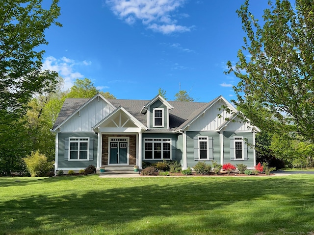 view of front of house featuring a front lawn and board and batten siding