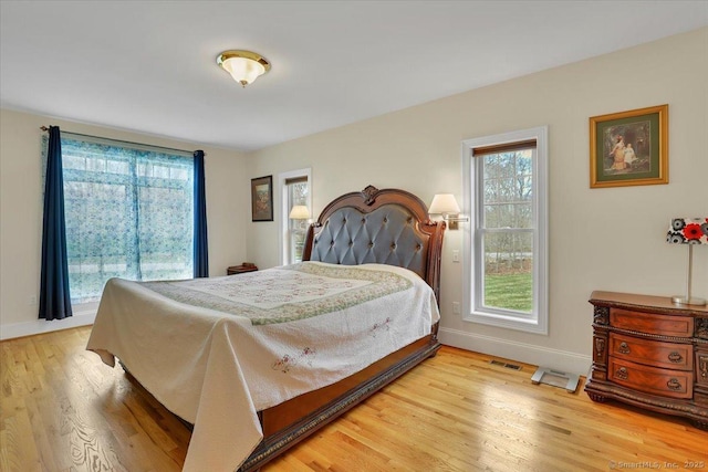 bedroom with baseboards and light wood-style floors