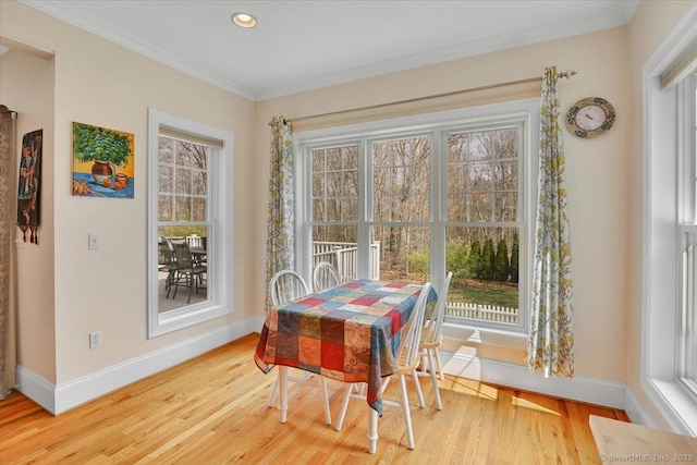 dining area featuring baseboards, wood finished floors, ornamental molding, and recessed lighting