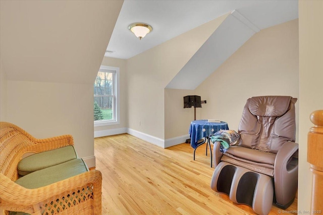 sitting room with vaulted ceiling, wood finished floors, and baseboards