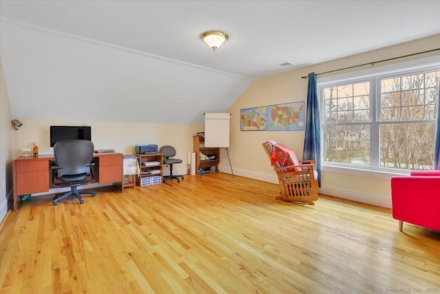 office area featuring wood finished floors, vaulted ceiling, and baseboards