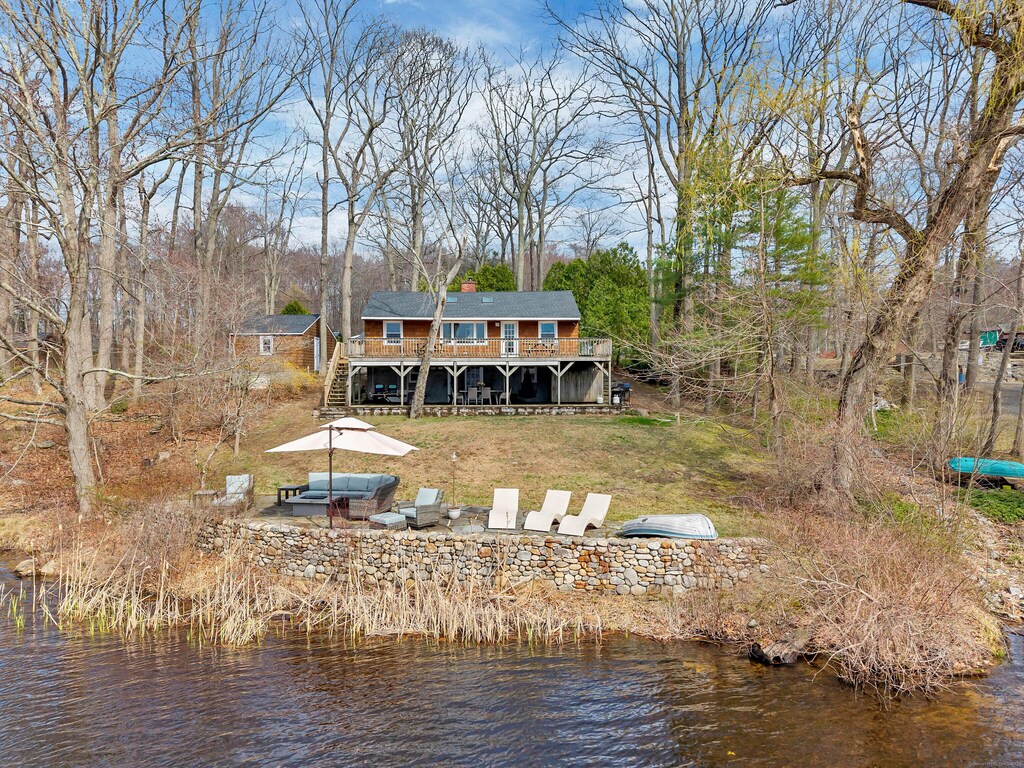 85 E Shore Dr, Haddam, CT 06441 - rear view of house featuring a deck with water view, a chimney, and stairway
