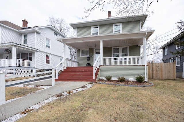 87 Englewood Ave, Waterbury, CT 06705 - traditional style home with a chimney, a front yard, covered porch, and fence
