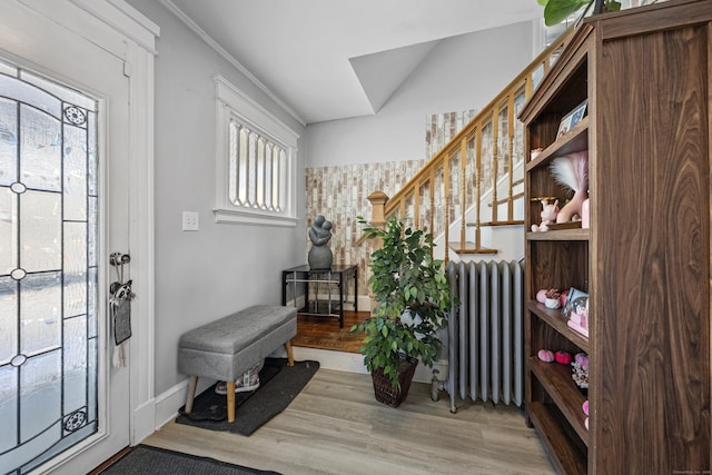 87 Englewood Ave, Waterbury, CT 06705 - foyer with radiator, wood finished floors, and stairway
