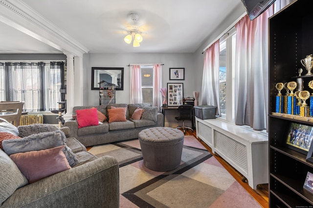 87 Englewood Ave, Waterbury, CT 06705 - living room with ceiling fan, decorative columns, wood finished floors, and plenty of natural light