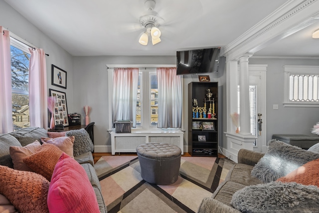 87 Englewood Ave, Waterbury, CT 06705 - living room with radiator heating unit, ornamental molding, baseboards, decorative columns, and ceiling fan