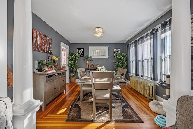 87 Englewood Ave, Waterbury, CT 06705 - dining space with radiator, wood-type flooring, and ornate columns