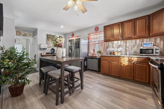 87 Englewood Ave, Waterbury, CT 06705 - kitchen featuring stainless steel appliances, a ceiling fan, brown cabinetry, and plenty of natural light