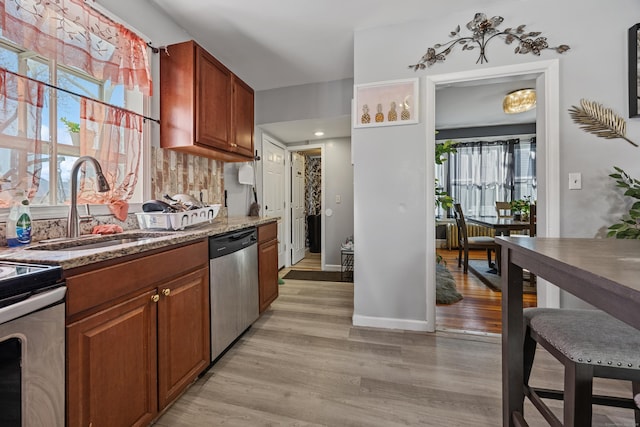 87 Englewood Ave, Waterbury, CT 06705 - kitchen with light stone counters, a sink, brown cabinetry, light wood-style floors, and stainless steel appliances