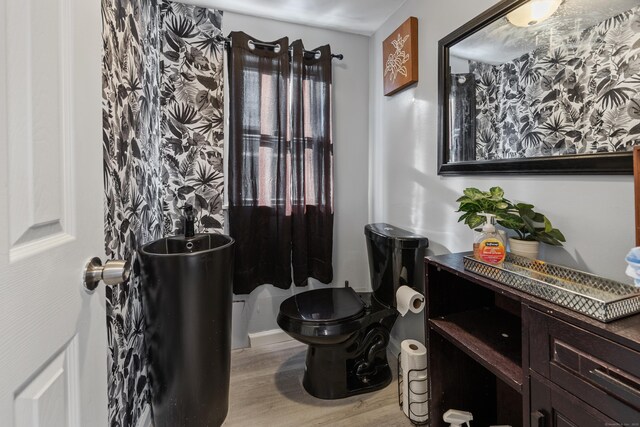 87 Englewood Ave, Waterbury, CT 06705 - half bathroom featuring wood finished floors and toilet