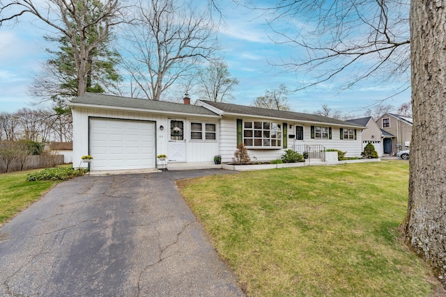 33 Wagon Rd, Enfield, CT 06082 - ranch-style house featuring a chimney, a front lawn, aphalt driveway, and a garage