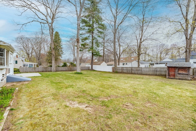 33 Wagon Rd, Enfield, CT 06082 - view of yard featuring a fenced backyard, an outdoor structure, a storage shed, and a residential view