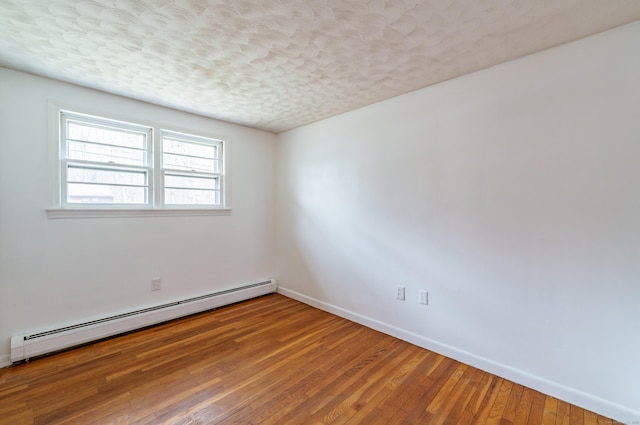33 Wagon Rd, Enfield, CT 06082 - spare room with a baseboard heating unit, baseboards, hardwood / wood-style floors, and a textured ceiling