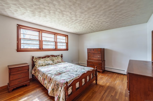 33 Wagon Rd, Enfield, CT 06082 - bedroom with hardwood / wood-style floors, baseboard heating, and a textured ceiling