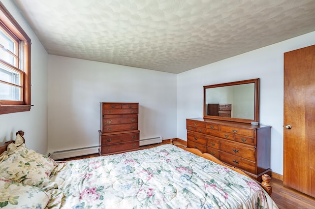 33 Wagon Rd, Enfield, CT 06082 - bedroom featuring a baseboard radiator, baseboards, and wood finished floors