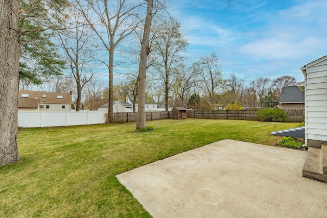33 Wagon Rd, Enfield, CT 06082 - view of yard featuring an outdoor structure, a patio area, a shed, and a fenced backyard