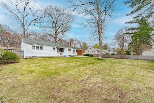33 Wagon Rd, Enfield, CT 06082 - back of house with a yard, a chimney, and fence
