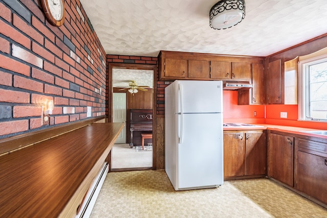 33 Wagon Rd, Enfield, CT 06082 - kitchen featuring a ceiling fan, brown cabinets, white appliances, brick wall, and under cabinet range hood