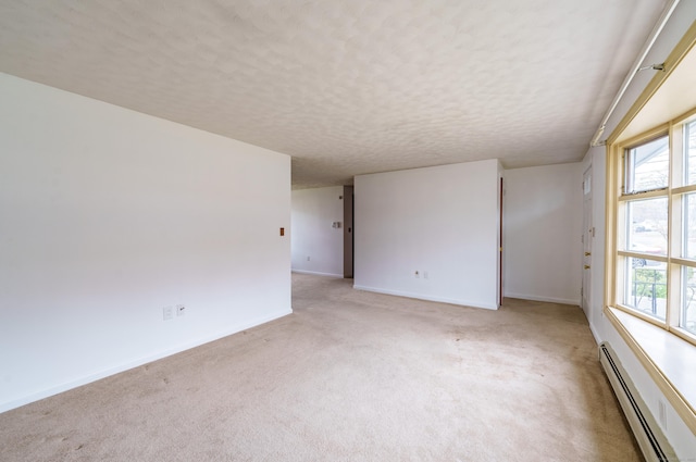 33 Wagon Rd, Enfield, CT 06082 - spare room featuring light carpet, a textured ceiling, plenty of natural light, baseboards, and a baseboard radiator