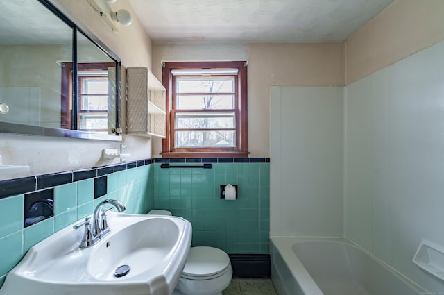 33 Wagon Rd, Enfield, CT 06082 - bathroom featuring toilet, tile walls, a sink, and plenty of natural light