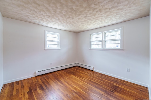 33 Wagon Rd, Enfield, CT 06082 - spare room featuring wood-type flooring, baseboards, a baseboard heating unit, and baseboard heating