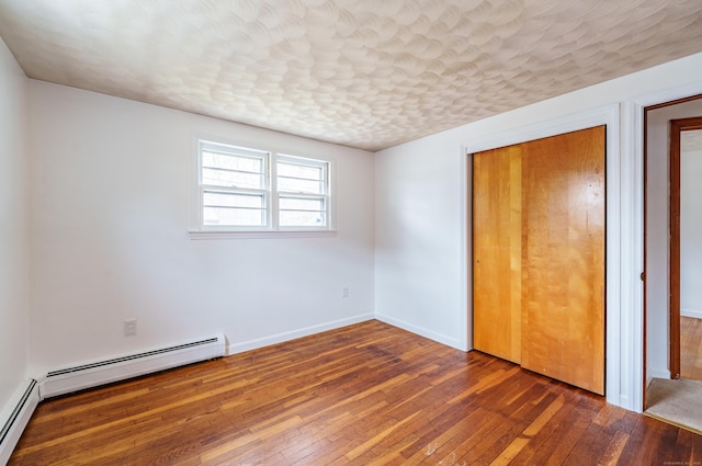 33 Wagon Rd, Enfield, CT 06082 - unfurnished bedroom with baseboards, hardwood / wood-style flooring, a closet, and baseboard heating