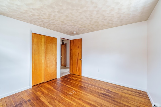 33 Wagon Rd, Enfield, CT 06082 - unfurnished bedroom featuring wood-type flooring, baseboards, and a closet