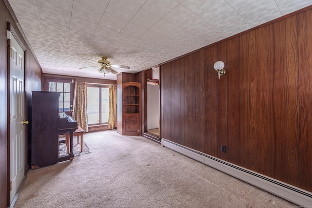 33 Wagon Rd, Enfield, CT 06082 - unfurnished living room with ceiling fan, wooden walls, carpet, and a baseboard radiator