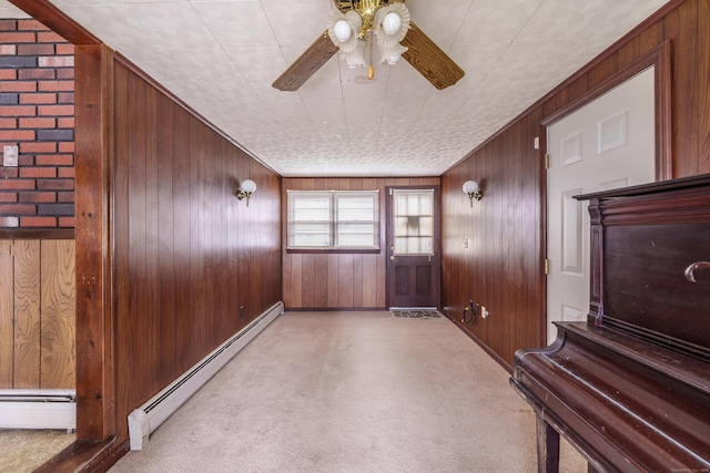33 Wagon Rd, Enfield, CT 06082 - interior space featuring a baseboard heating unit, wooden walls, baseboards, and ceiling fan