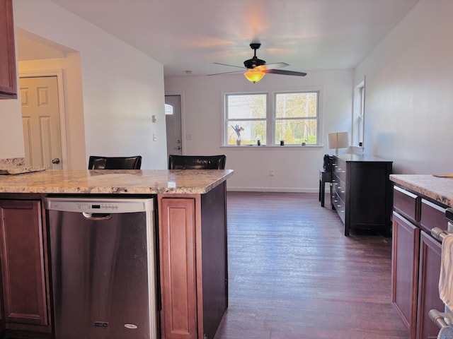 kitchen featuring stainless steel dishwasher, dark wood-style flooring, baseboards, ceiling fan, and light stone counters