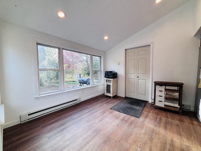 spare room with wood finished floors, baseboards, a baseboard heating unit, vaulted ceiling, and recessed lighting