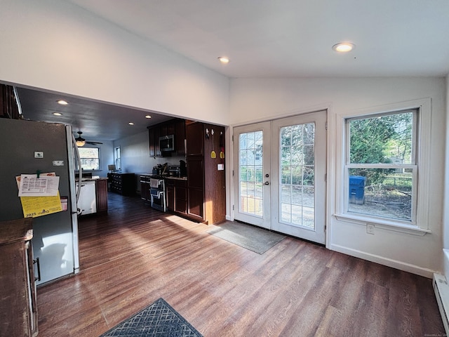 doorway to outside with a ceiling fan, baseboard heating, french doors, dark wood finished floors, and vaulted ceiling