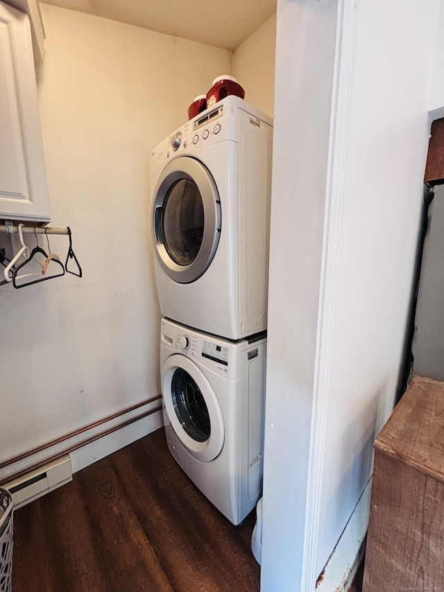 laundry area featuring laundry area, dark wood-style floors, and stacked washer and dryer