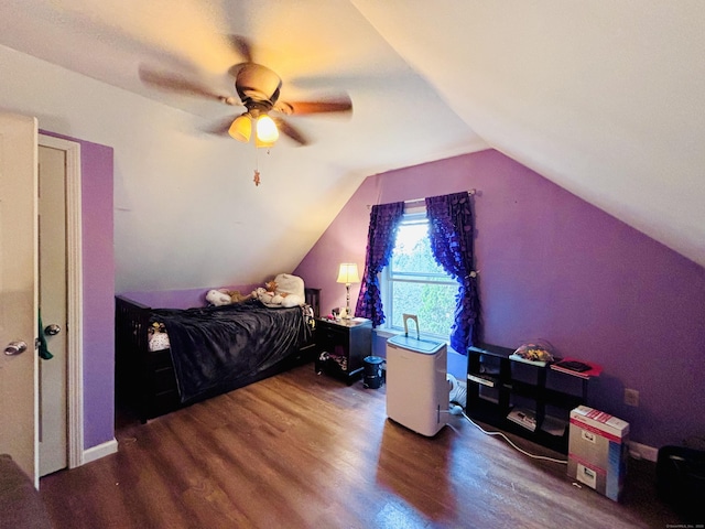 bedroom with ceiling fan, lofted ceiling, and wood finished floors