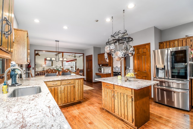 3 Huntington Ln, New Fairfield, CT 06812 - kitchen featuring stainless steel fridge, a sink, a chandelier, light wood-style floors, and recessed lighting