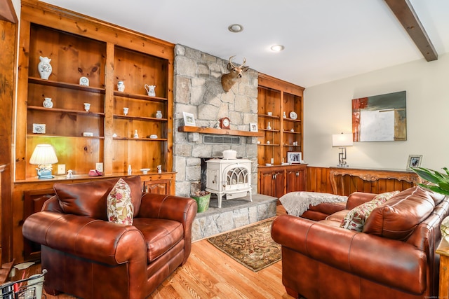 3 Huntington Ln, New Fairfield, CT 06812 - living area featuring wood finished floors, a wood stove, and beam ceiling