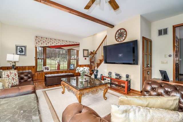 3 Huntington Ln, New Fairfield, CT 06812 - living area featuring wood finished floors, stairway, a wainscoted wall, a ceiling fan, and beam ceiling