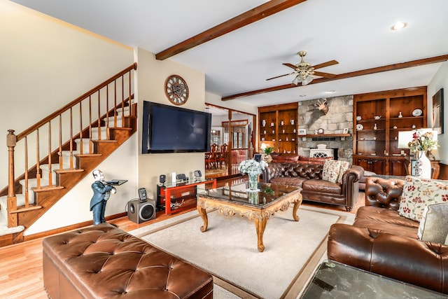 3 Huntington Ln, New Fairfield, CT 06812 - living room with beam ceiling, wood finished floors, stairway, a ceiling fan, and a stone fireplace