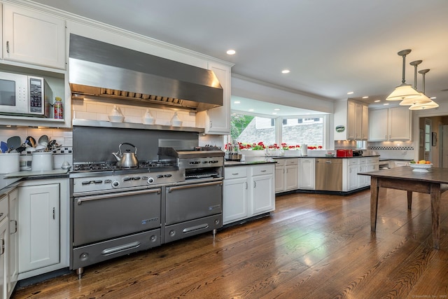 8 Bayberry Hl, Roxbury, CT 06783 - kitchen featuring wall chimney range hood, double oven range, dark countertops, backsplash, and dark wood-style flooring