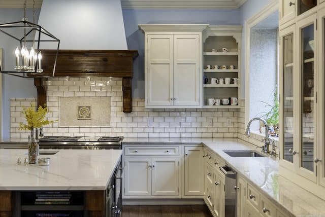17 Wardwell Dr, New Canaan, CT 06840 - kitchen featuring a sink, stainless steel dishwasher, open shelves, a chandelier, and decorative backsplash