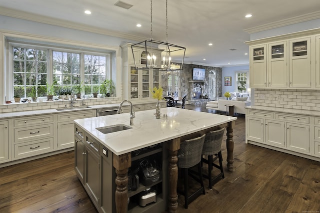 17 Wardwell Dr, New Canaan, CT 06840 - kitchen featuring a sink, ornamental molding, tasteful backsplash, recessed lighting, and a kitchen bar