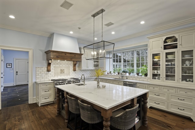 17 Wardwell Dr, New Canaan, CT 06840 - kitchen with appliances with stainless steel finishes, ornamental molding, a sink, a chandelier, and light stone counters
