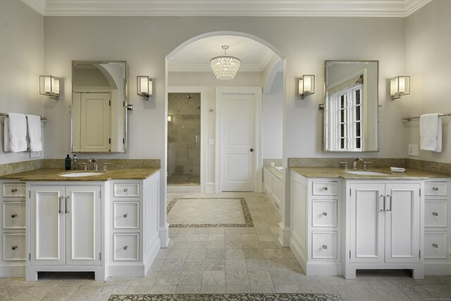 17 Wardwell Dr, New Canaan, CT 06840 - full bathroom with a shower stall, two vanities, crown molding, baseboards, and a chandelier