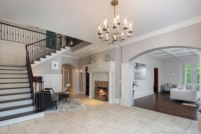 17 Wardwell Dr, New Canaan, CT 06840 - living area with arched walkways, stone tile floors, crown molding, stairs, and coffered ceiling