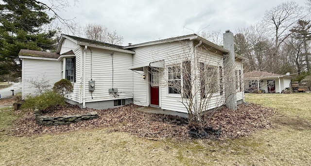 44 Red Bridge Rd, Thompson, CT 06255 - view of side of property featuring a chimney and a yard