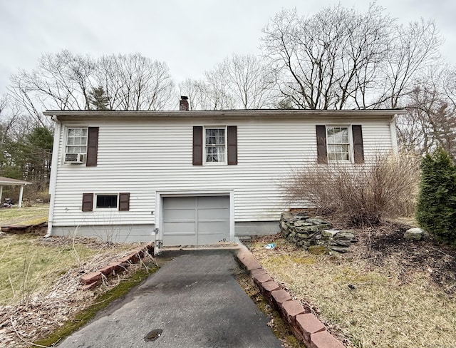44 Red Bridge Rd, Thompson, CT 06255 - view of front facade featuring asphalt driveway, an attached garage, and a chimney