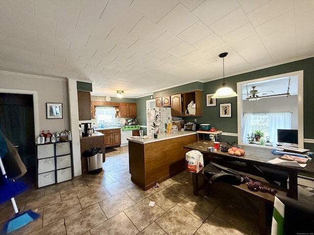 44 Red Bridge Rd, Thompson, CT 06255 - kitchen with ornamental molding, a peninsula, white fridge with ice dispenser, brown cabinets, and light countertops