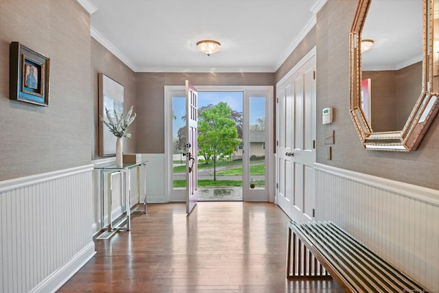 doorway featuring wood finished floors, wainscoting, and ornamental molding