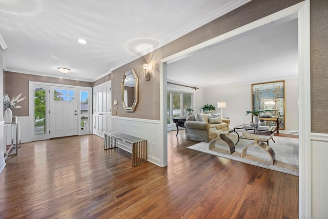 foyer featuring crown molding, wood finished floors, and wainscoting