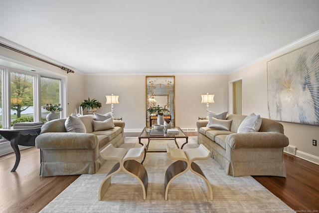 living room with wood finished floors, ornamental molding, and baseboards